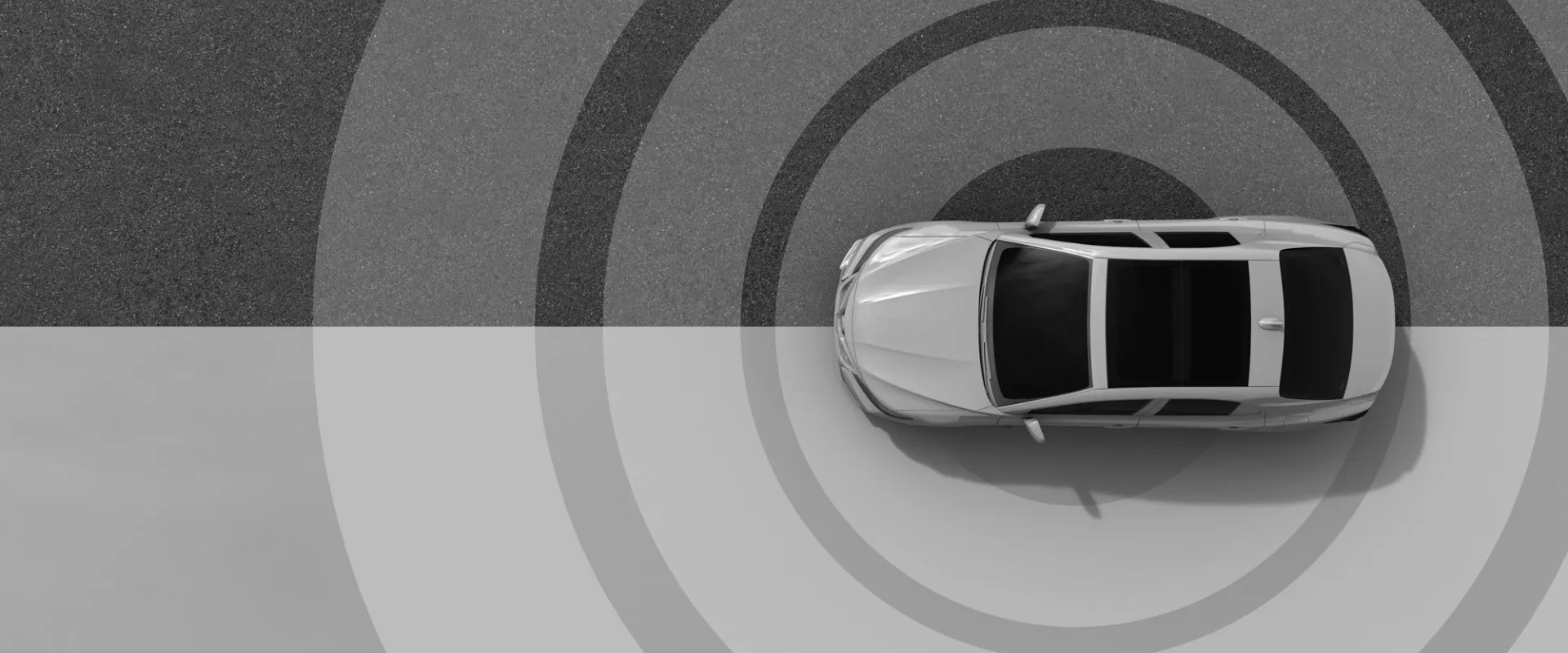 Top view of a car with radar-like circles, symbolizing sensing technology.